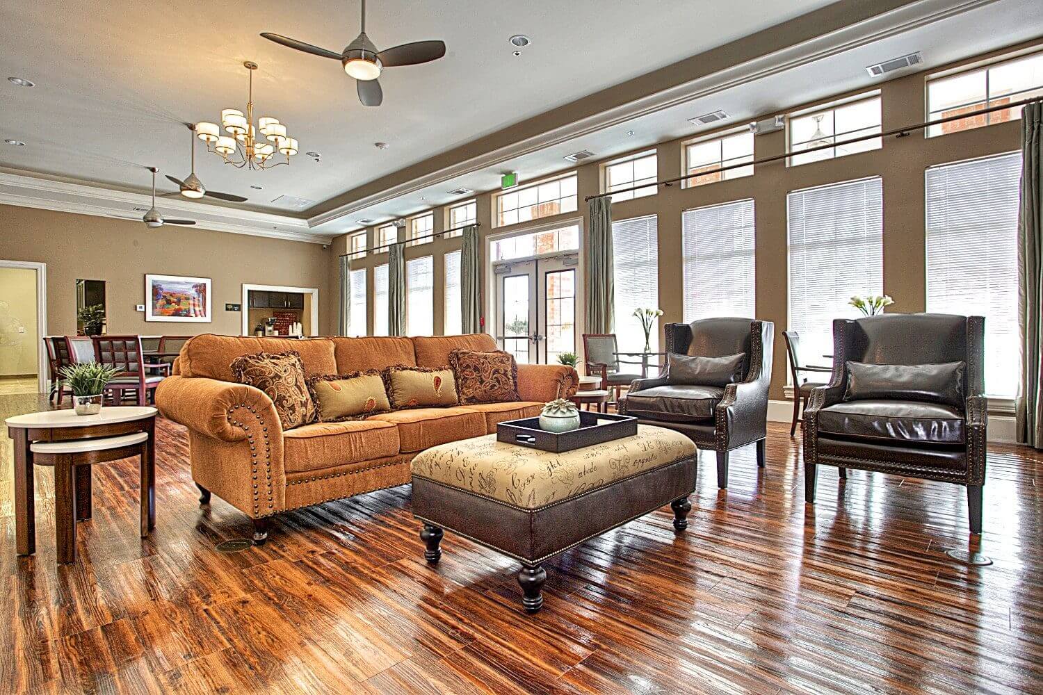 Spacious living room with large windows and stylish furniture.